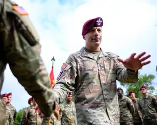 A man in uniform waves