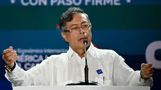 Colombian President Gustavo Petro wearing a white shirt on stage at an event in Panama City on 26 January