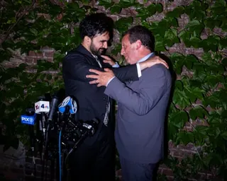 Mamdani and Lander embrace in front of microphones