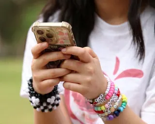A girl's arms holding a phone