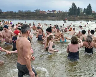 People walk into the lake for the new year swim