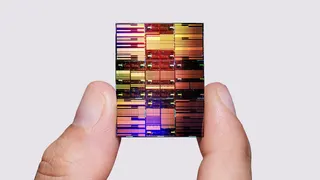 Researcher holding IBM's sub-1 nm node chip