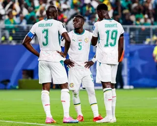 Senegal players look disappointed.
