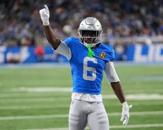 Terrion Arnold holds a hand up after a play during a Detroit Lions game in 2025.