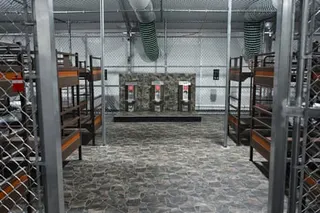beds and toilets inside a makeshift detention center