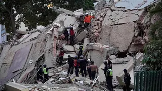 Rescuers search for victims in a collapsed building following an earthquake in Caracas on June 24, 2026.