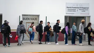 Asylum seekers stand in line at the El Chaparral crossing port at the U.S.-Mexico border in Tijuana, Baja California State, Mexico, on June 5, 2024.
