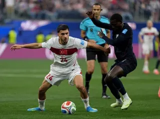 Oguz Aydin of Turkiye in action against Tim Weah of USA