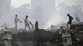 Volunteers search for possible victims in a collapsed building following twin earthquakes in Venezuela.