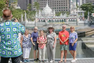 Tourists take pictures in front of Masjid Jamek in Kuala Lumpur. BMI forecasts Malaysia will welcome 27.97 million international visitors this year, exceeding pre-pandemic levels despite a softer second quarter. — Picture by Raymond Manuel