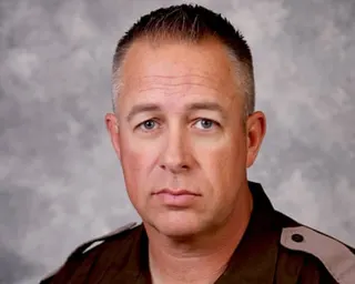man wearing uniform looks ahead in portrait
