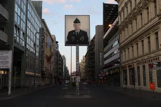 The lightbox installation 'Untitled' depicting an American soldier looking towards the east, is pictured next to the former Berlin Wall border crossing point Checkpoint Charlie in Berlin, Germany, June 25, 2026.  — Reuters pic