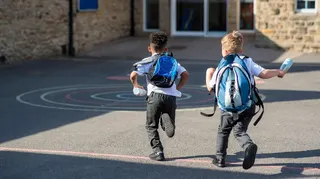 Children run to school in the sunshine