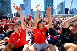 Soccer Football - FIFA World Cup 2026 - Round of 32 - South Africa v Canada - Fans gather in Vancouver - Vancouver, Canada - June 28, 2026 Canada fan celebrate their first goal scored by Stephen Eustaquio, as they watch the match at Jack Poole Plaza REUTERS/Albert Gea
