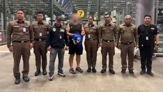 Police officers pose with man with face blurred
