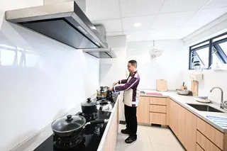 Senior bus captain Tian Yinfu inside the kitchen of his apartment during the official opening of SBS Transit’s SQ@Sengkang West.