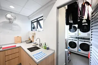 The kitchen and laundry facilities of an apartment at SBS Transit’s SQ@Sengkang West.