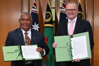Vanuatu’s Prime Minister Jotham Napat (left) and Australian Prime Minister Anthony Albanese present the signed Nakamal agreement at  Parliament House in Canberra on Monday. Photo: EPA