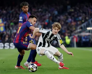 Anthony Gordon, playing for Newcastle, battles with Eric Garcia of Barcelona during their Champions League last-16 leg game at the Camp Nou in March 2026