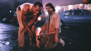 Danny Glover and Mel Gibson stand on the set of L'Arme Fatale on Hollywood Boulevard.