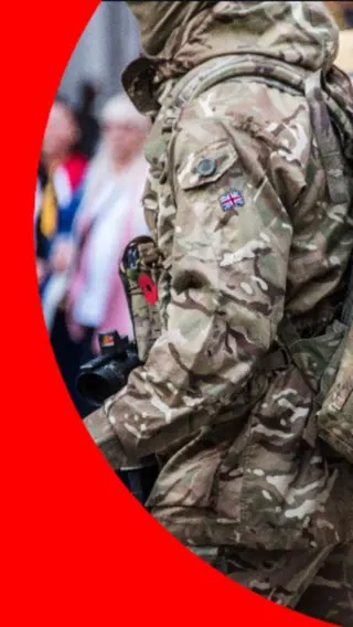 A person wearing army fatigues without their face visible
