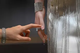 A woman touches a humanoid robot's hand during the launch of the U1 humanoid robot produced by UWORLD, a brand under UBTECH Robotics, in Shenzhen, China's Guangdong province on June 30, 2026. Silicone skin, soothing voice: Chinese company UBTech unveiled unprecedented hyper-realistic human-looking androids equipped with artificial intelligence (AI) and presented as anti-loneliness remedies. (Photo by ADEK BERRY / AFP)