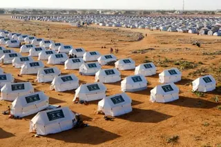 Lines of white tents display the logo of the Kingdom of Saudi Arabia