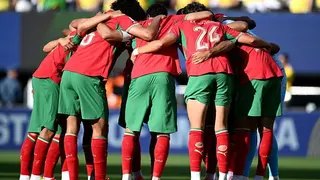 Morocco players in red shirts and green shorts form a huddle before their 2026 World Cup match against Brazil in New Jersey on 13 June