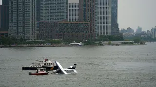 Emergency services respond to a crashed seaplane in the East River on 5 July in New York City.