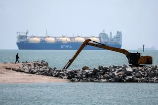 A worker walks past the liquefied natural gas tanker ETYFA-Prometheas in the Malacca Strait in April. The Strait of Malacca is the world’s largest oil chokepoint in terms of transit volume. Photo: EPA