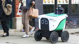 A delivery robot on a sidewalk in Chicago