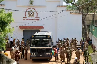 Prisoners board a bus to be transferred to another prison following clashes between two groups of inmates at Negombo prison in the coastal town of Negombo, Sri Lanka on Monday. Photo: Reuters