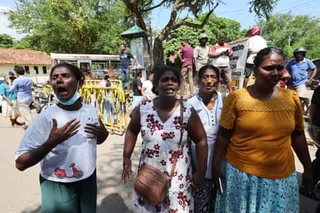 Relatives of peopple killed in overnight clashes protest as a bus carrying prisoners leaves the Negombo jail.
