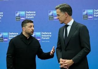 Zelenskyy raises a hand as he speaks to Rutte