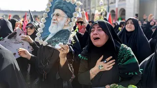 A woman weeps as people gather at the Imam Khomeini Grand Mosalla for a farewell ceremony for Iran's late Ayatollah Ali Khamenei
