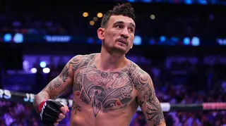 Max Holloway is shirtless and in a UFC octagon