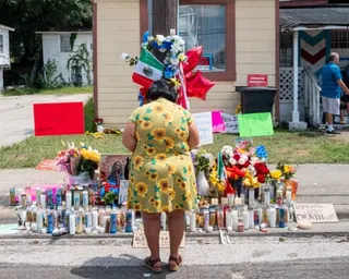 A woman pays respect at the site where Mexican immigrant Lorenzo Salgado Araujo was killed.