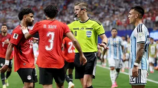 Referee Francois Letexier separates Marawan Attia of Egypt and Lautaro Martinez of Argentina during their World Cup match