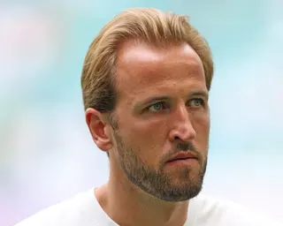 Harry Kane looks upward with a serious expression