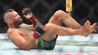 Conor McGregor lies on his back in the octagon