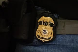 A gold badge reading 'ICE U.S. OFFICER' with an eagle on top hangs from a belt