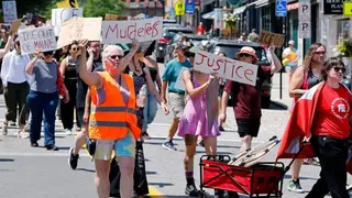 Protesters holding anti-ICE signs in Maine