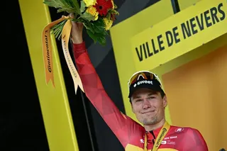 Uno-X Mobility team's Norwegian rider Soren Waerenskjold celebrates on the podium after winning the 11th stage of the 113th edition of the Tour de France cycling race, 161,3 km between Vichy and Nevers in central France