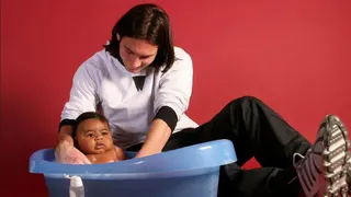 Lionel Messi cradles a baby Lamine Yamal in a bath in the away dressing room at Barcelona's Camp Nou stadium in 2007
