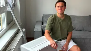 Denis Yurchak in a green t-shirt sitting beside his Midea PortaSplit