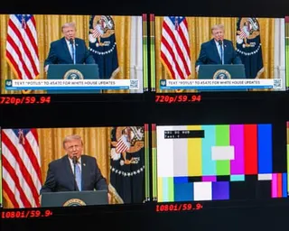 Four TV monitors in a square play the president, with the bottom right screen on a hold pattern.