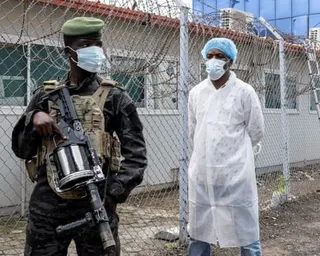 A member of the M23 rebel group stands guard as provincial authorities visit the Rodolphe Merieux Laboratory, National Biomedical Research Institute, where samples from suspected Ebola cases are tested,  in Goma, North Kivu province of the DRC, in May.