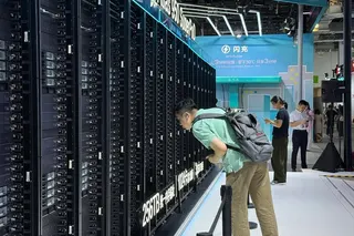A visitor leans in for a closer look at Huawei’s Atlas 950 SuperPod at the World AI Conference in Shanghai.