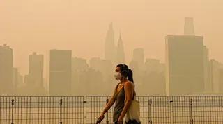 Smoke from massive wildfires in Canada engulfed the New York City skyline, reducing visibility and casting an orange haze over the New York City
