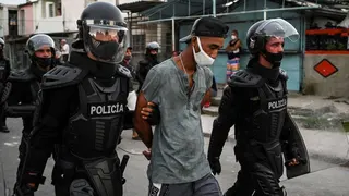 A man is arrested during a demonstration against the government of President Miguel Diaz-Canel in Arroyo Naranjo Municipality, Havana on July 12, 2021.